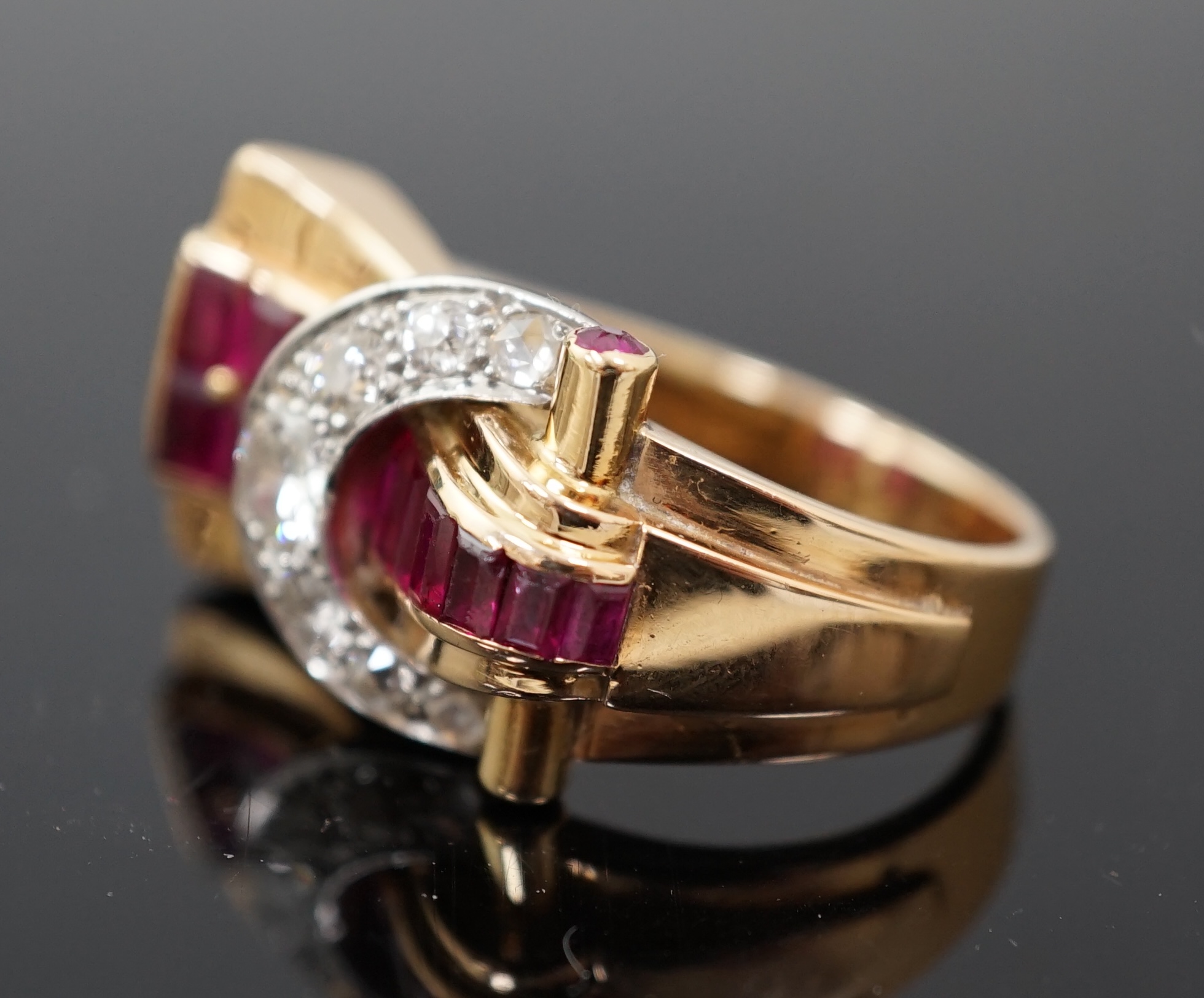 A 1950's continental gold, synthetic ruby, round and rose cut diamond cluster set fan shaped 'buckle' cocktail ring